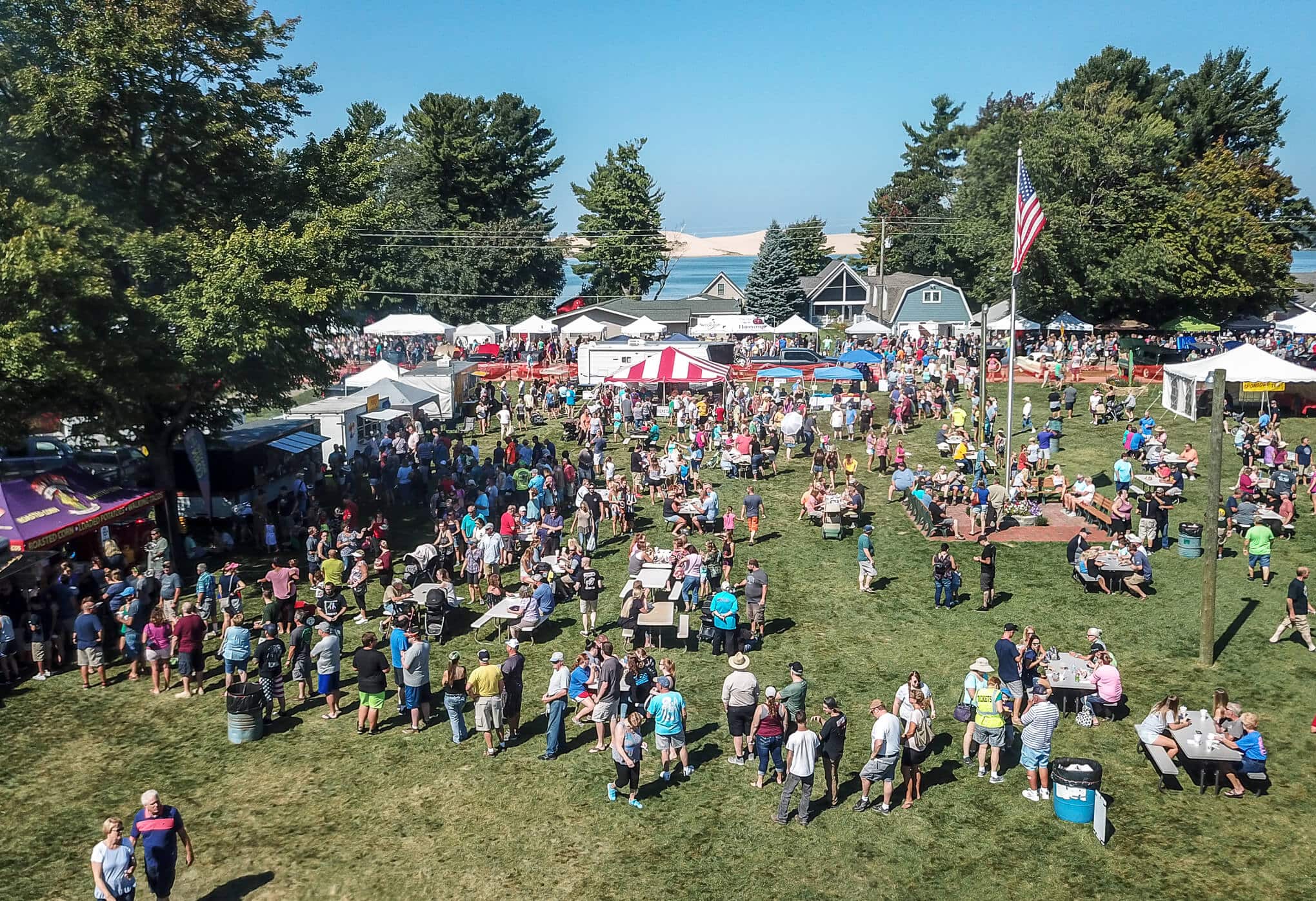 people playing games and eating food at the festival